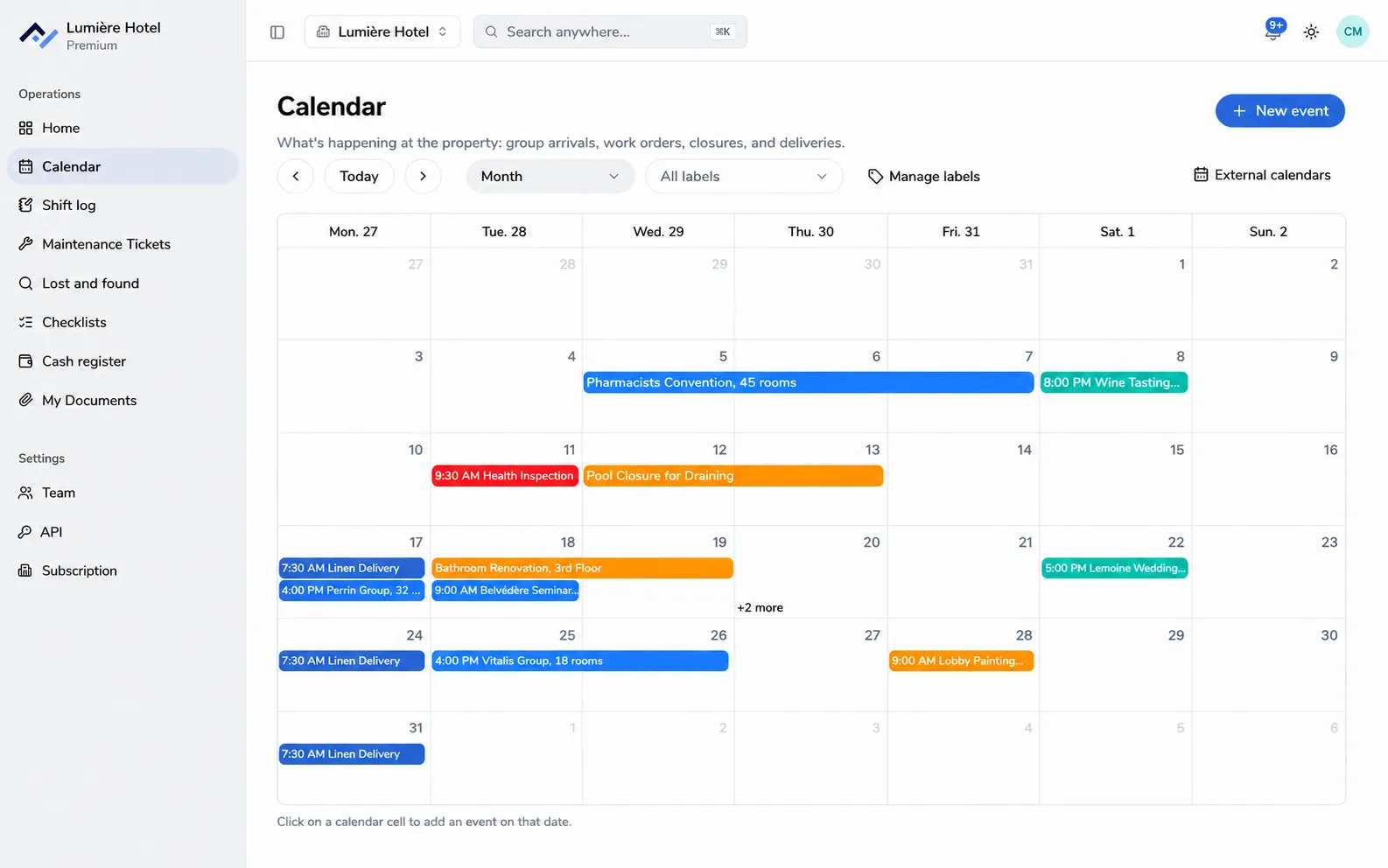 Front Desk's shared calendar shown in month view: group arrivals, works, inspections, and events, each in the color of its label.
